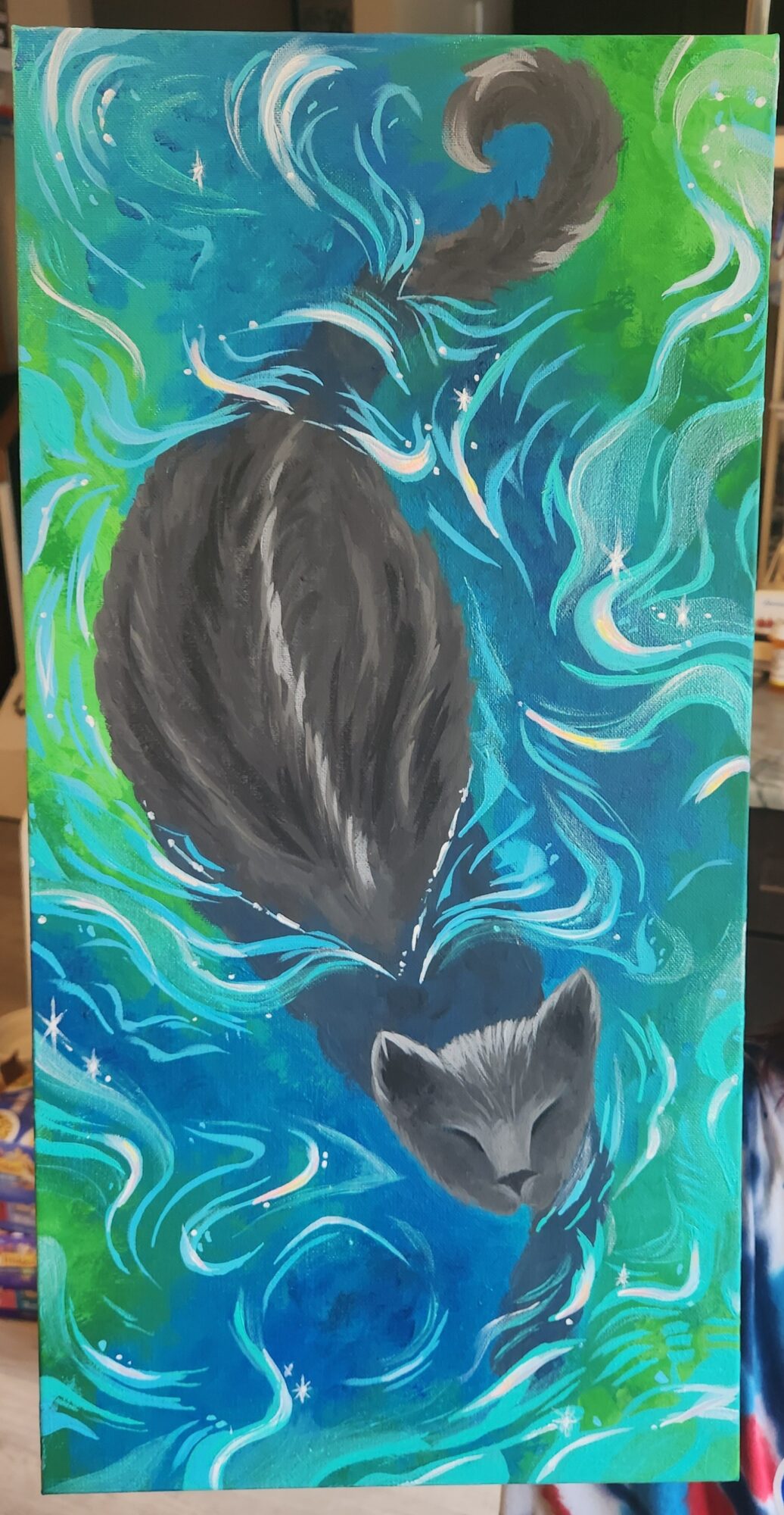 Black cat swimming in swirling blue and green water, with its tail curved upward and head submerged.