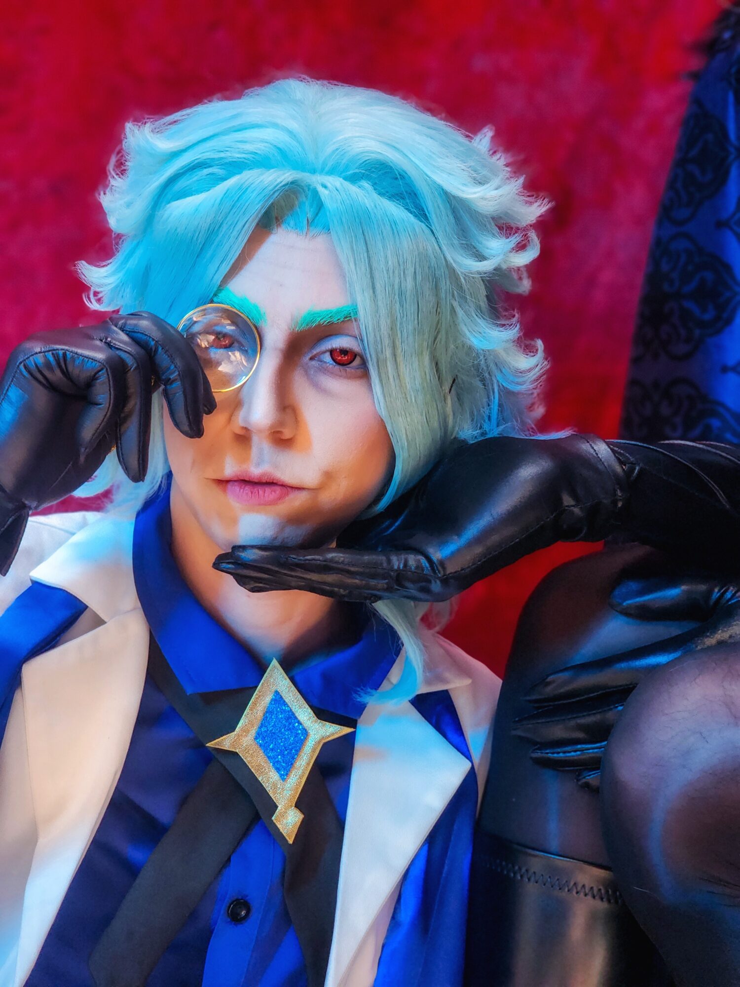 Person with light blue and gray hair holding a magnifying glass to one eye, wearing black gloves and a blue and white outfit.