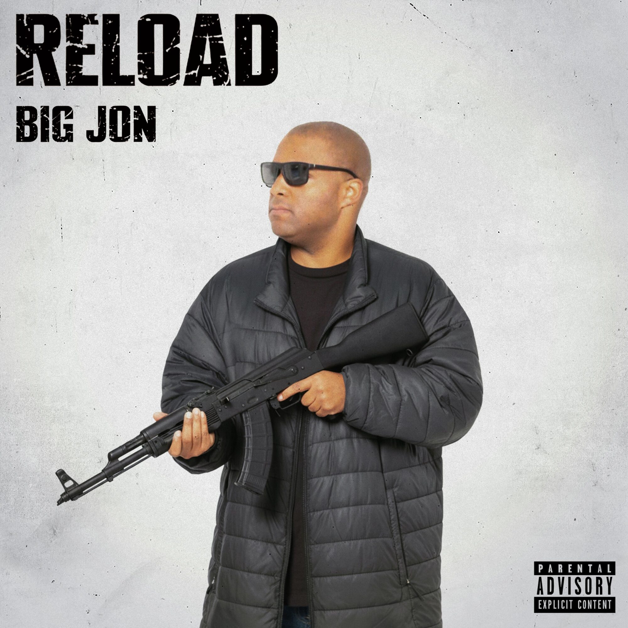 Man wearing sunglasses and a black jacket holding a rifle against a plain background.