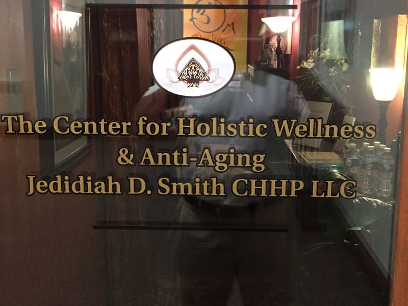 Text on glass reads 'The Center for Holistic Wellness & Anti-Aging, Jedidiah D. Smith CHHP LLC'.