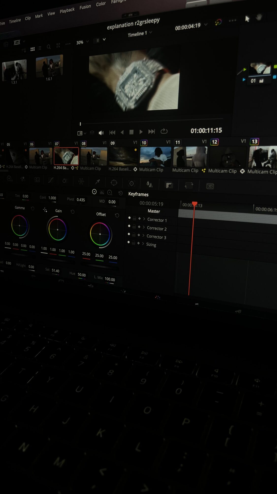 Computer screen displaying video editing software with timeline, color wheels, and a preview window.