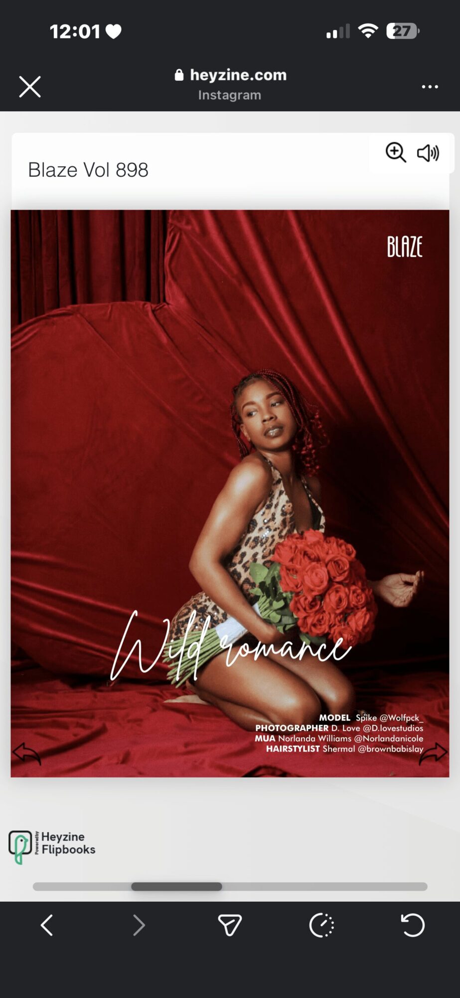 Woman in a dress holding flowers, sitting on a red backdrop with red curtains, looking at the camera.