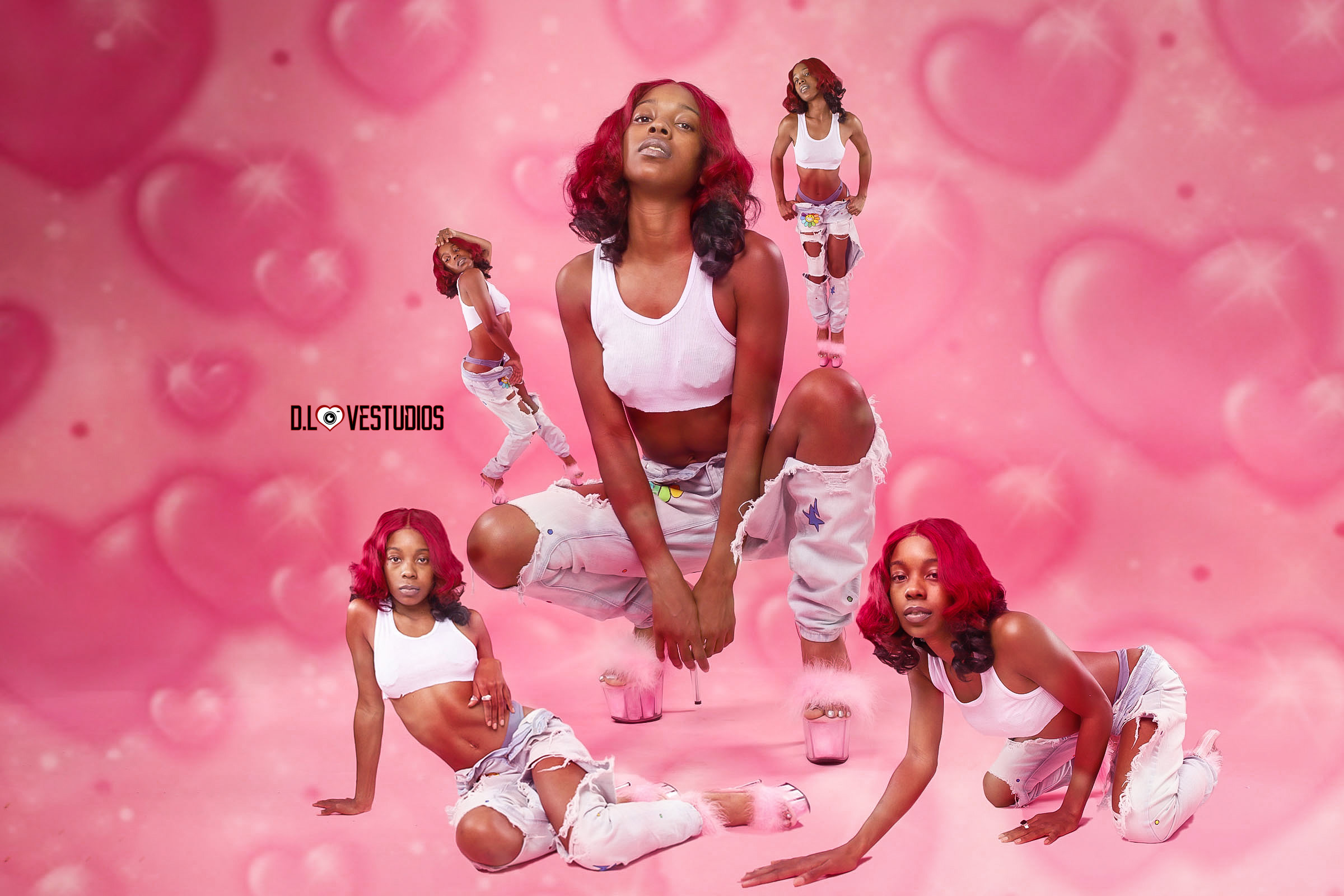 Group of five women in white outfits with pink hair poses on a pink heart-patterned background.