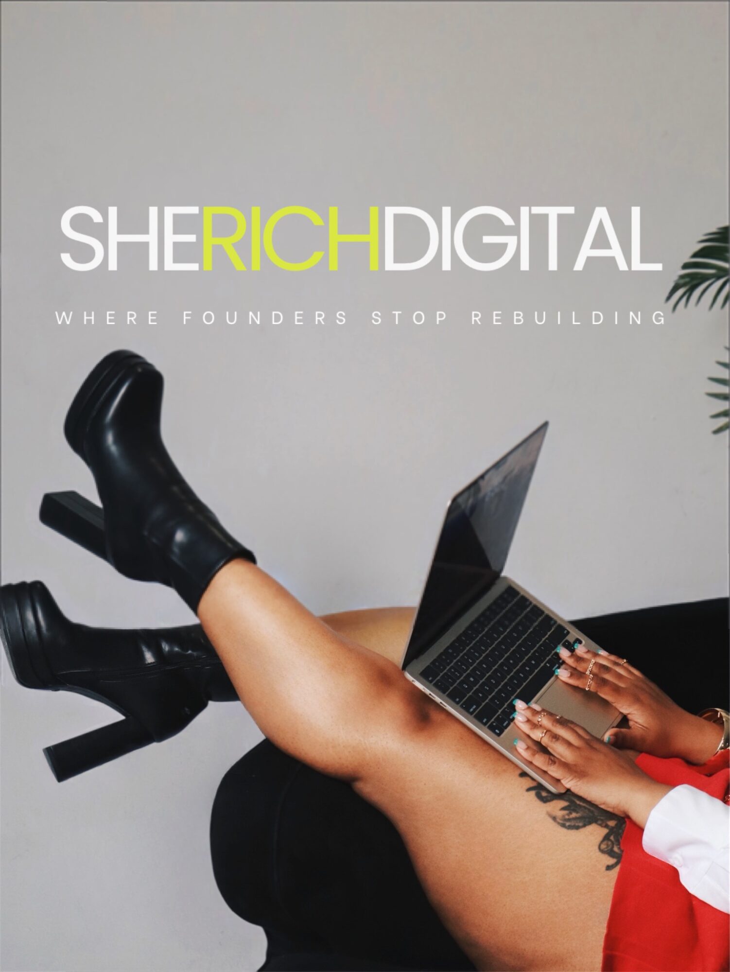 Person with legs up, using a laptop on their thighs, wearing black boots and red clothing, against a plain background.