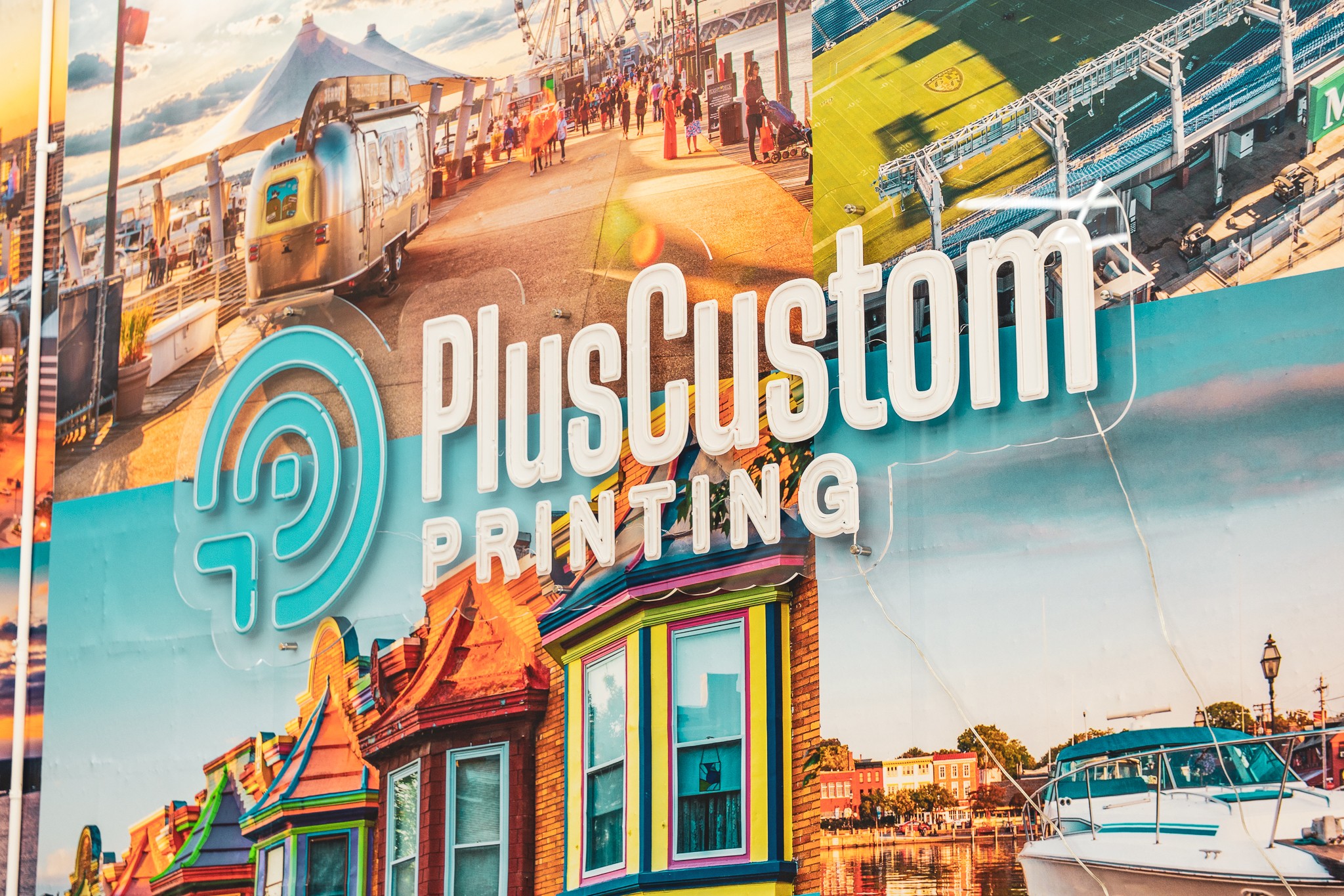 Collage of various printed images including a train, boats, and colorful buildings, with PlusCustom Printing logo overlay.