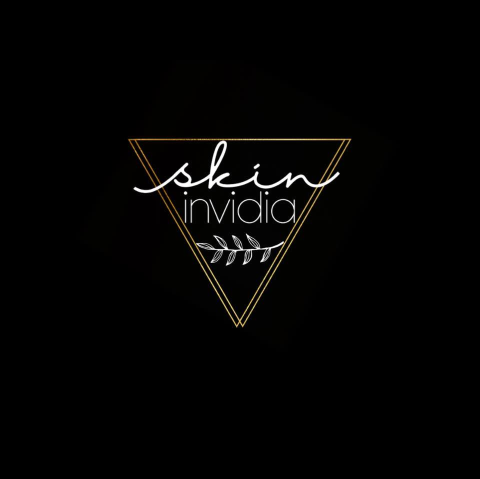 Logo with a triangle outline, the word 'skin' in cursive, 'invidia' below, and a small leaf design, on a black background.