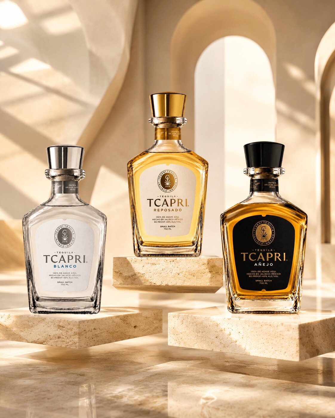 Three perfume bottles on a marble surface with sunlight and arches in the background.