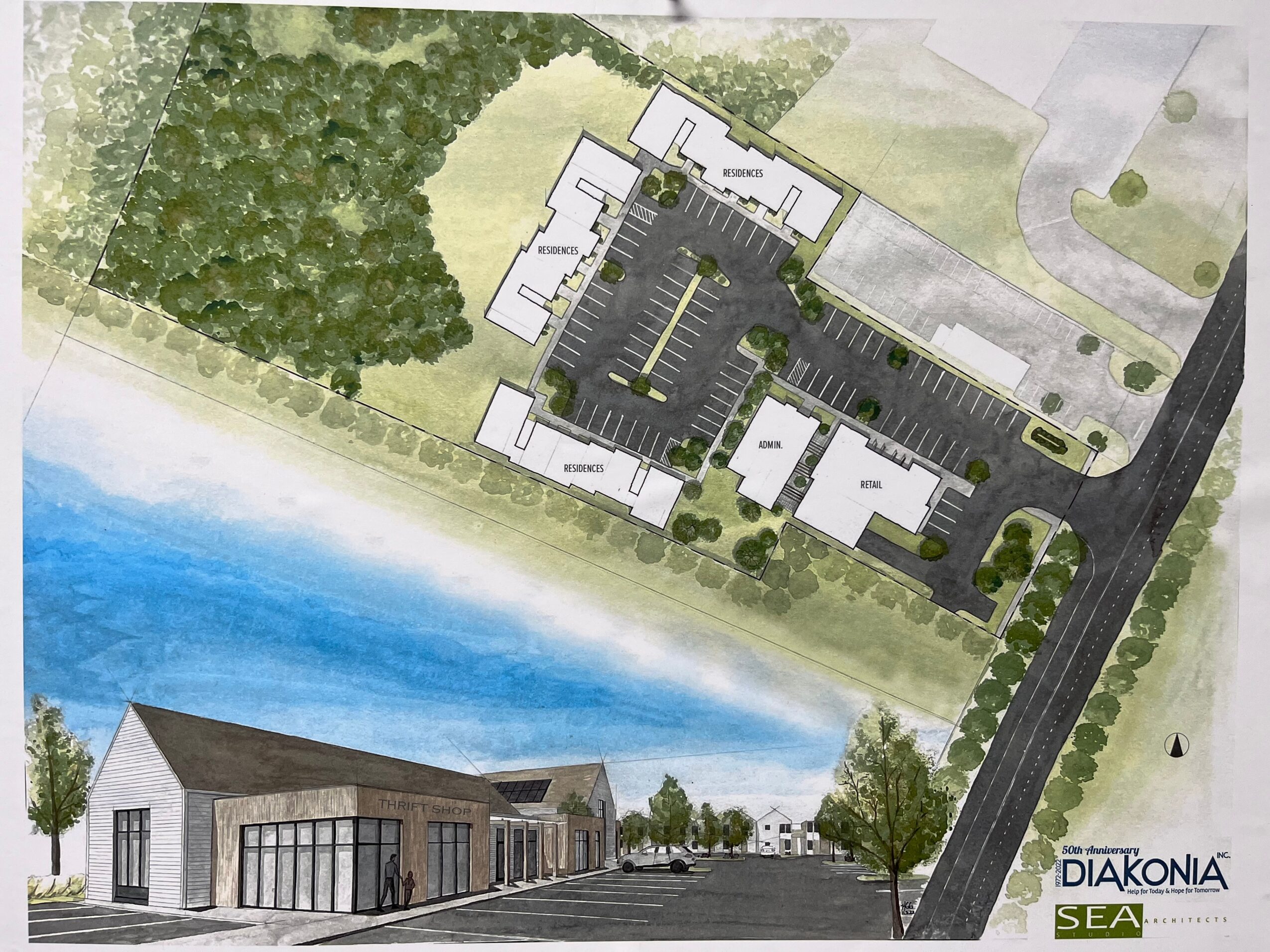A site plan showing a building near a body of water, with parking, trees, and surrounding roads, viewed from above.
