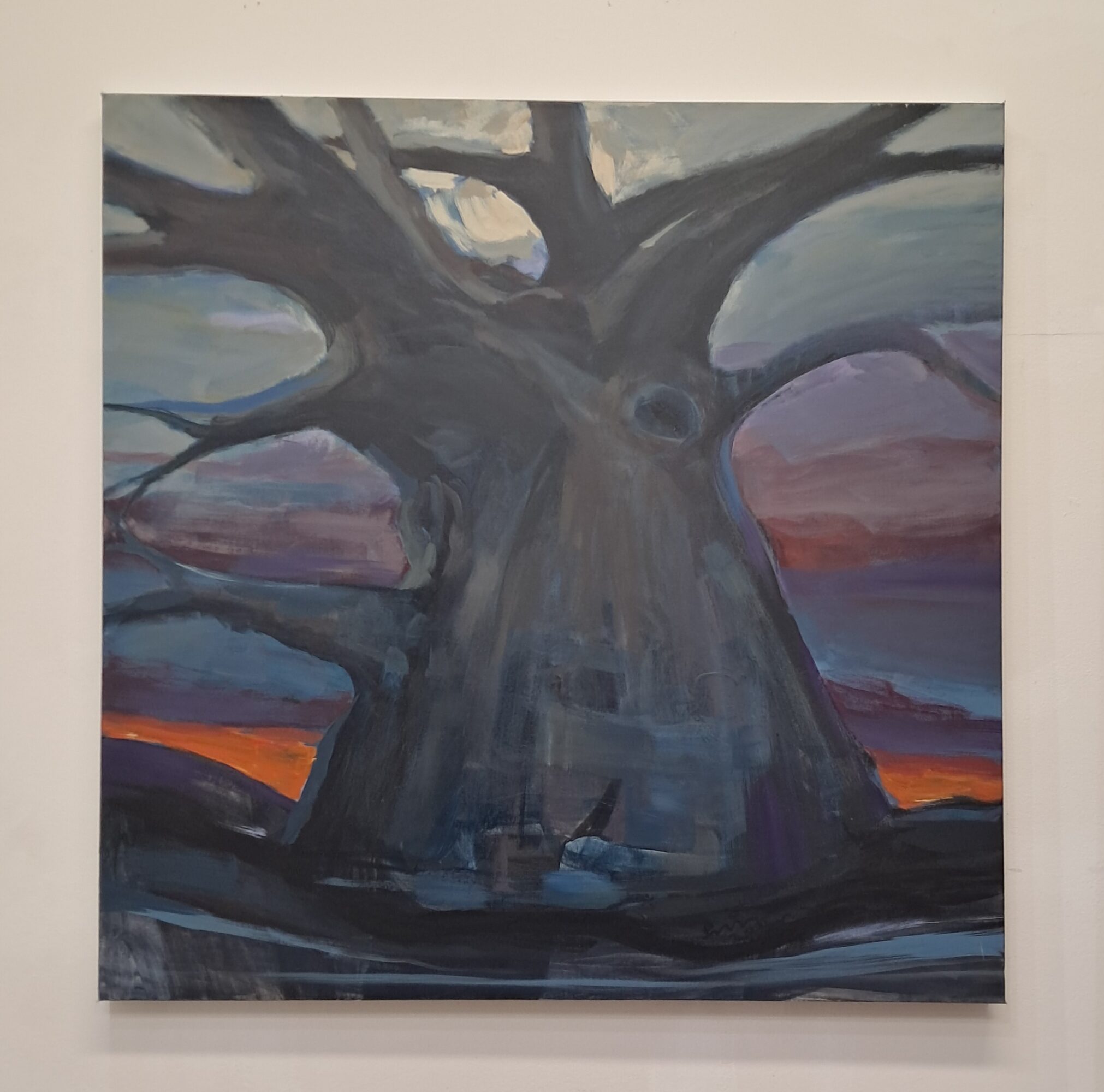 Painting of a large tree with a thick trunk and sprawling branches against a colorful sky at sunset.