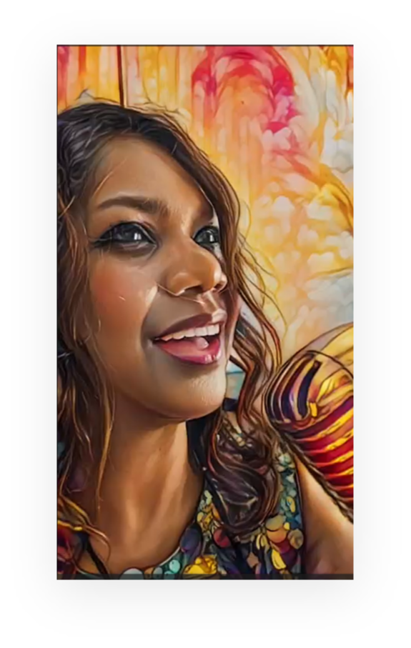 Close-up of a smiling woman with wavy hair, colorful background, and vibrant clothing.