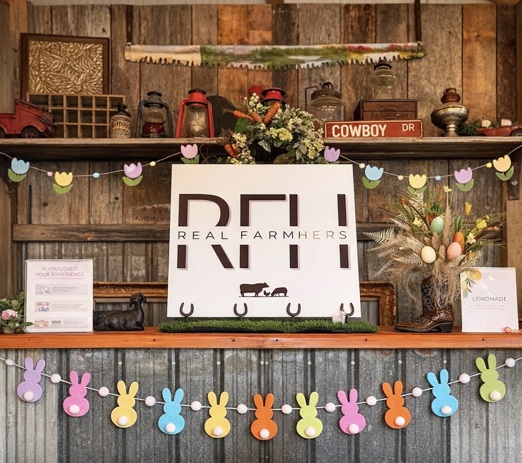 Wooden shelf with decorative items, a sign reading 'REAL FARMERS,' and colorful bunny-shaped garland.