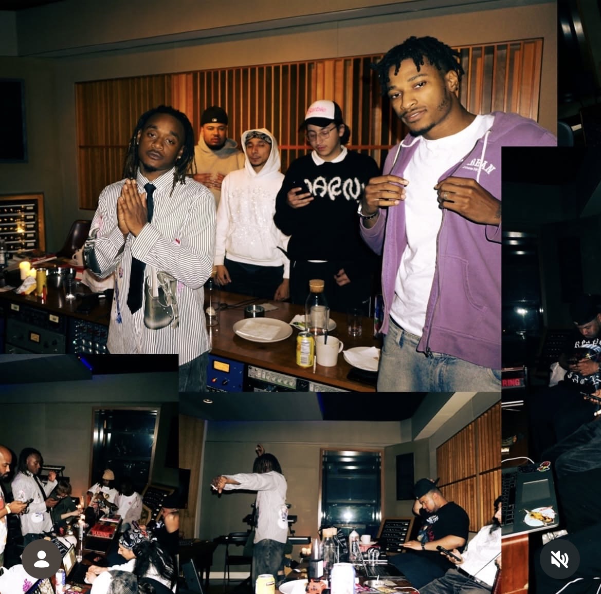 Group of people in a recording studio, some holding food, others working or talking, with equipment and tables visible.