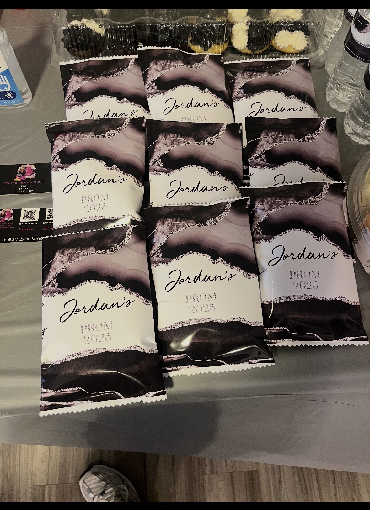 Nine small boxes labeled 'Jordans' arranged on a table, with other items partially visible around them.
