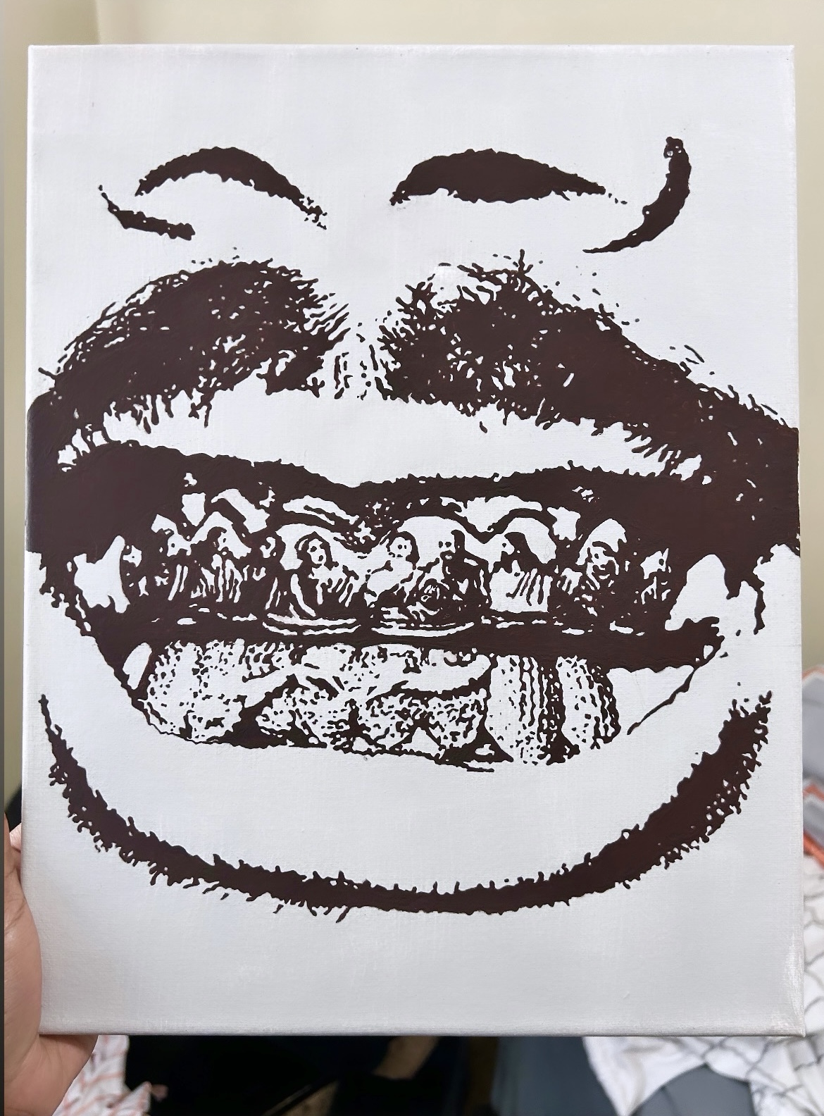 Black and white print of a smiling face with detailed teeth and lips, on a white background.