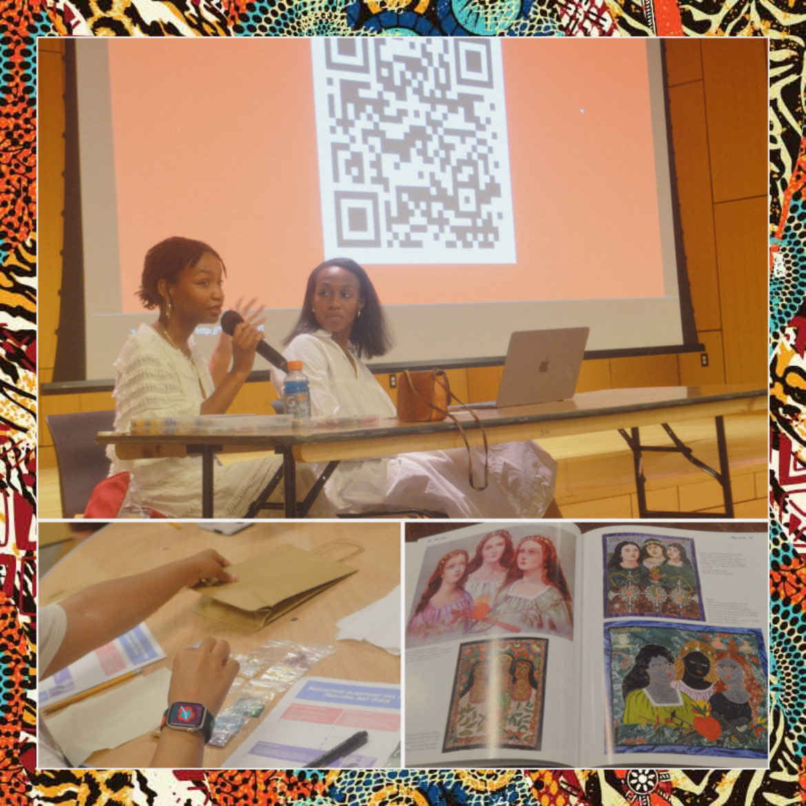 Two women sit at a table in front of a large screen displaying a QR code, with a laptop and water bottle, in a presentation setting.