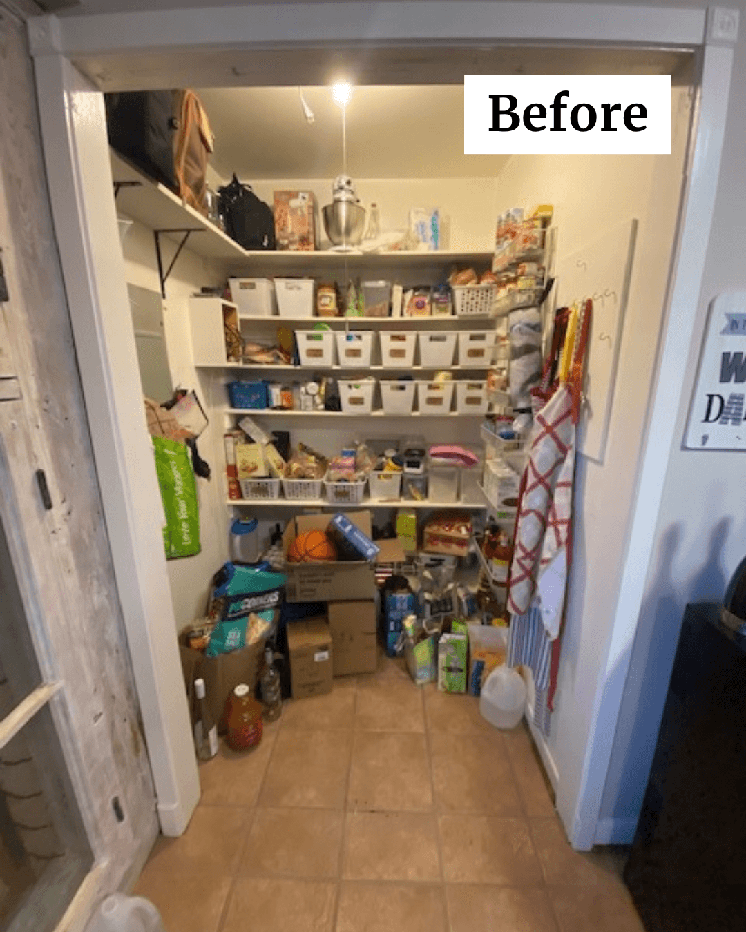 Closet with shelves filled with storage bins, boxes, and household items, with a red and white checkered apron hanging on the right.
