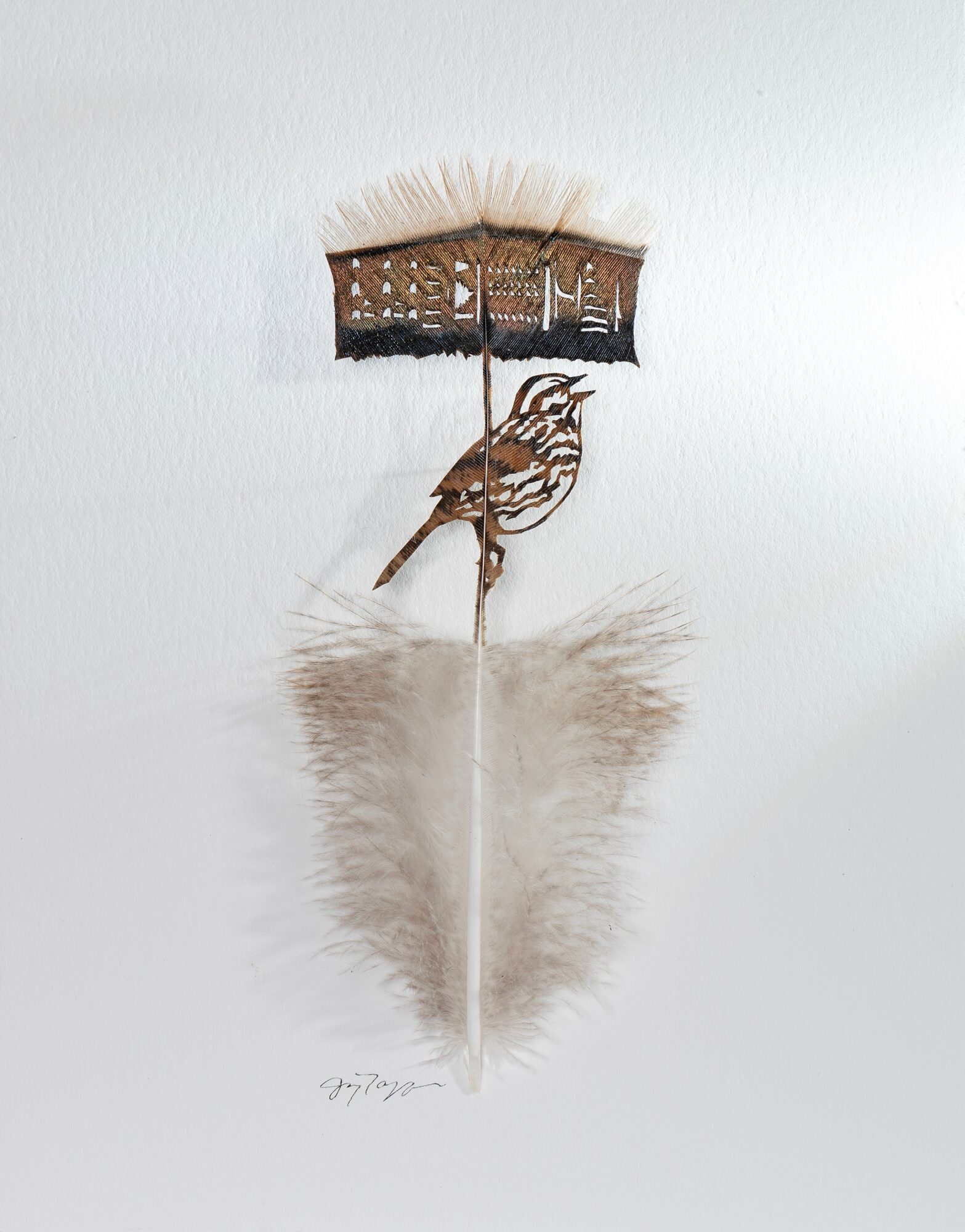 Decorative wall hanging with a bird, umbrella, and feather, reflected on a surface, with a white background.