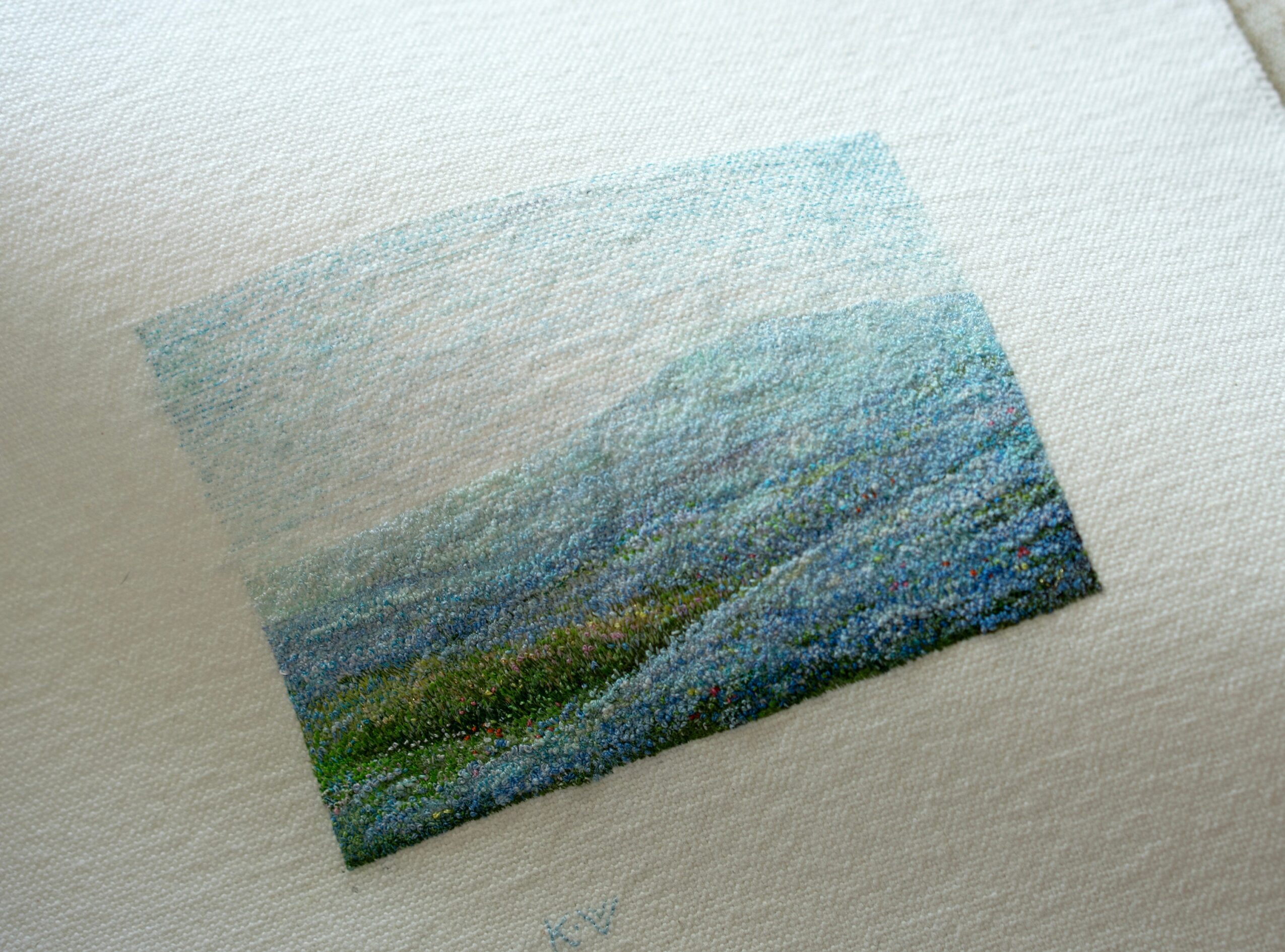 Small landscape painting of mountains, sky, and greenery, with textured brushstrokes, on white textured paper.