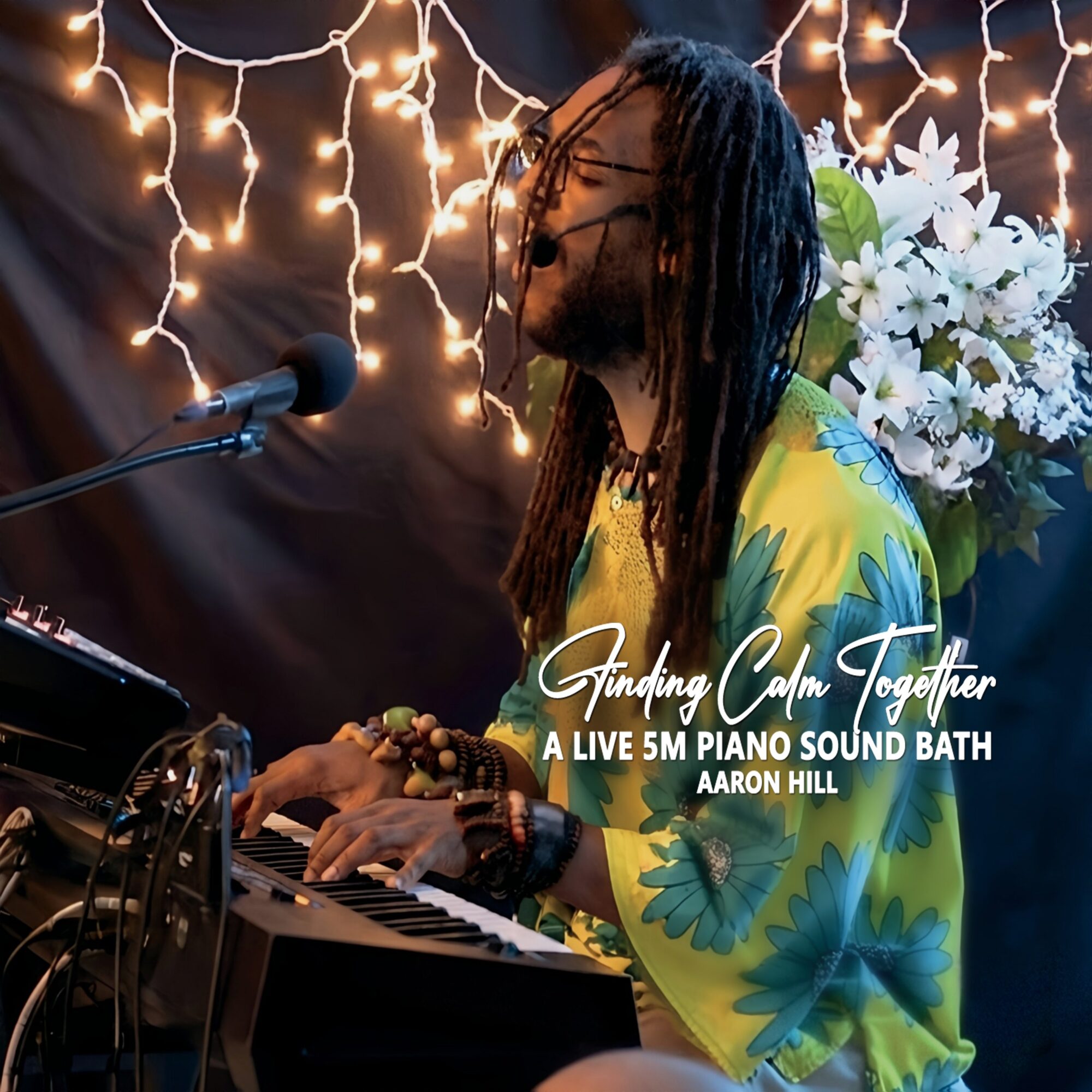 Person with long hair playing piano, decorated with string lights and flowers, performing at an event, with text overlay.