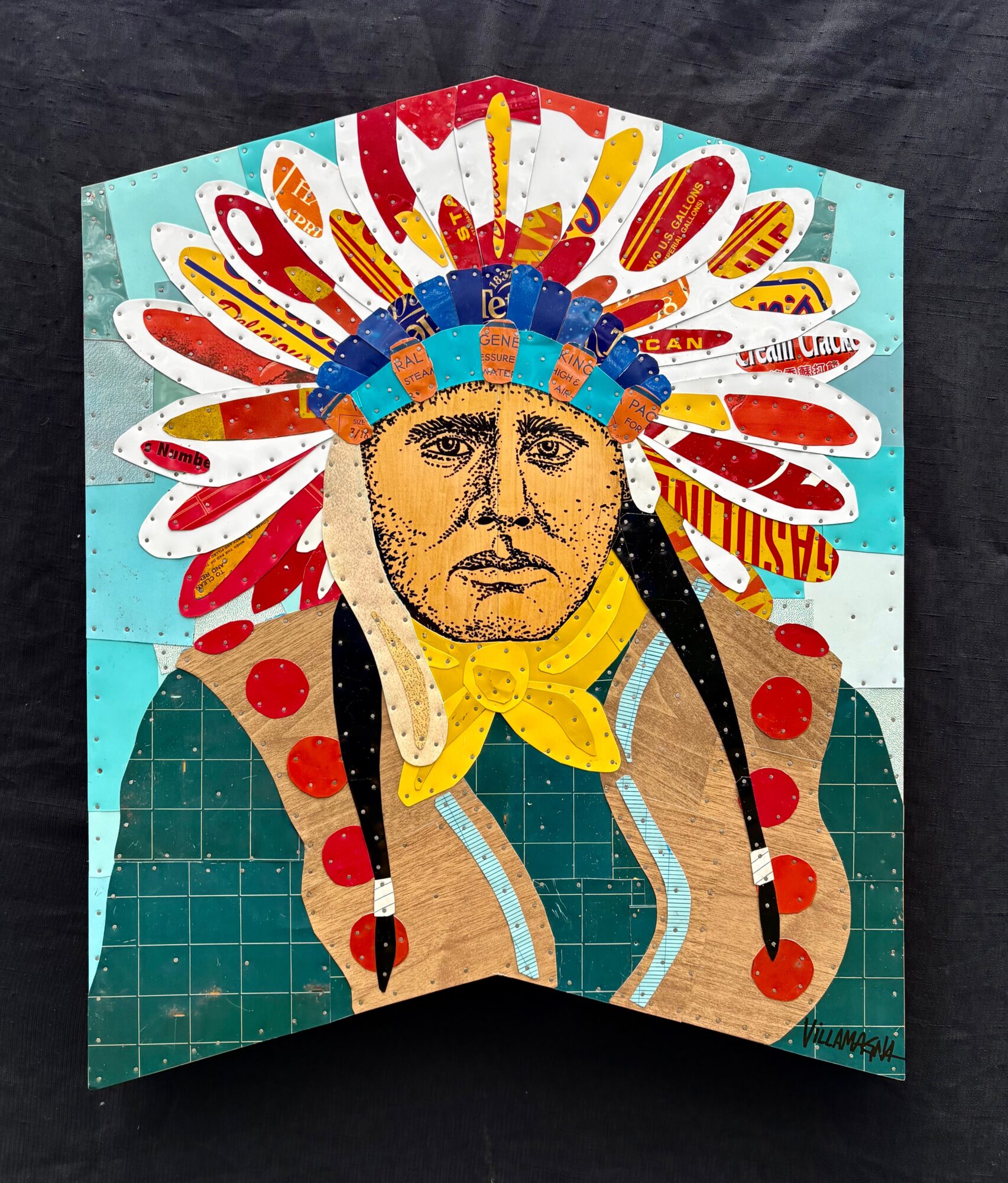 Colorful folded artwork depicting a person wearing a feathered headdress against a turquoise background.